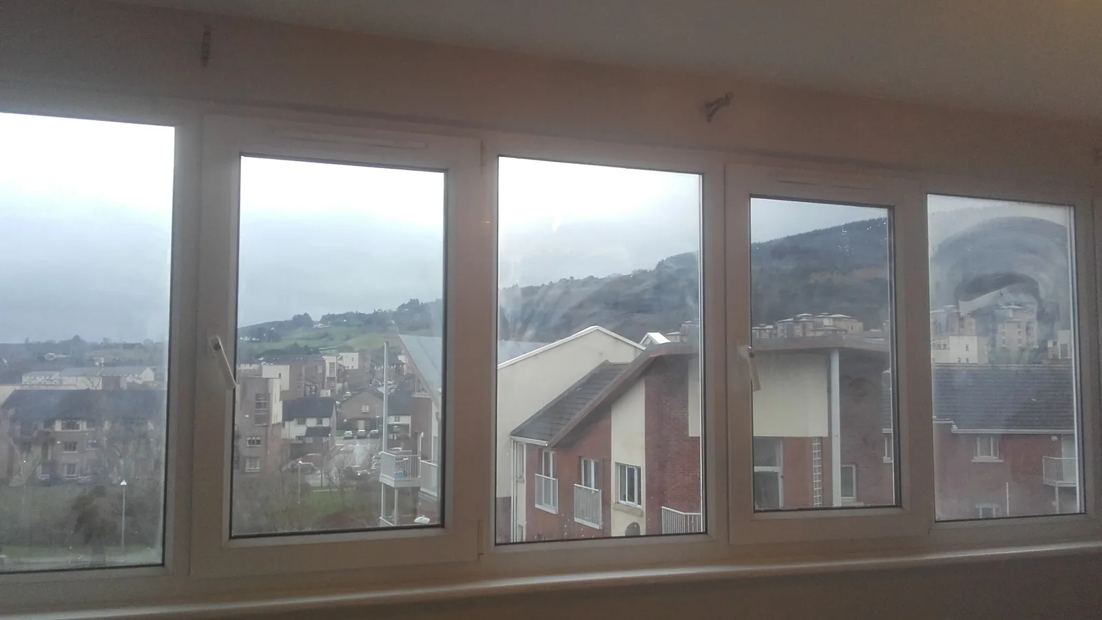 Newly installed white window units in a prepared wall opening